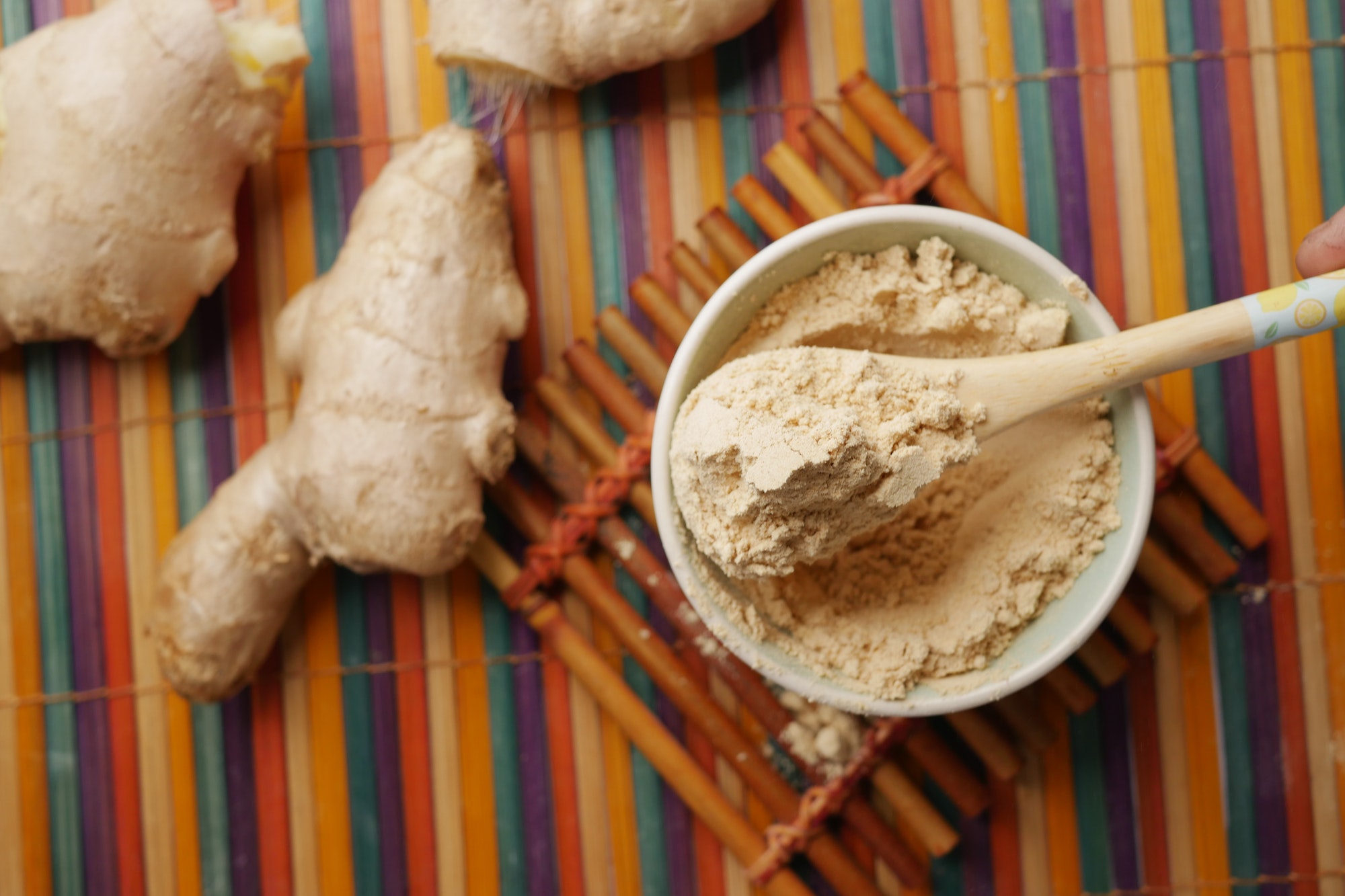 ginger powder and ginger on table .