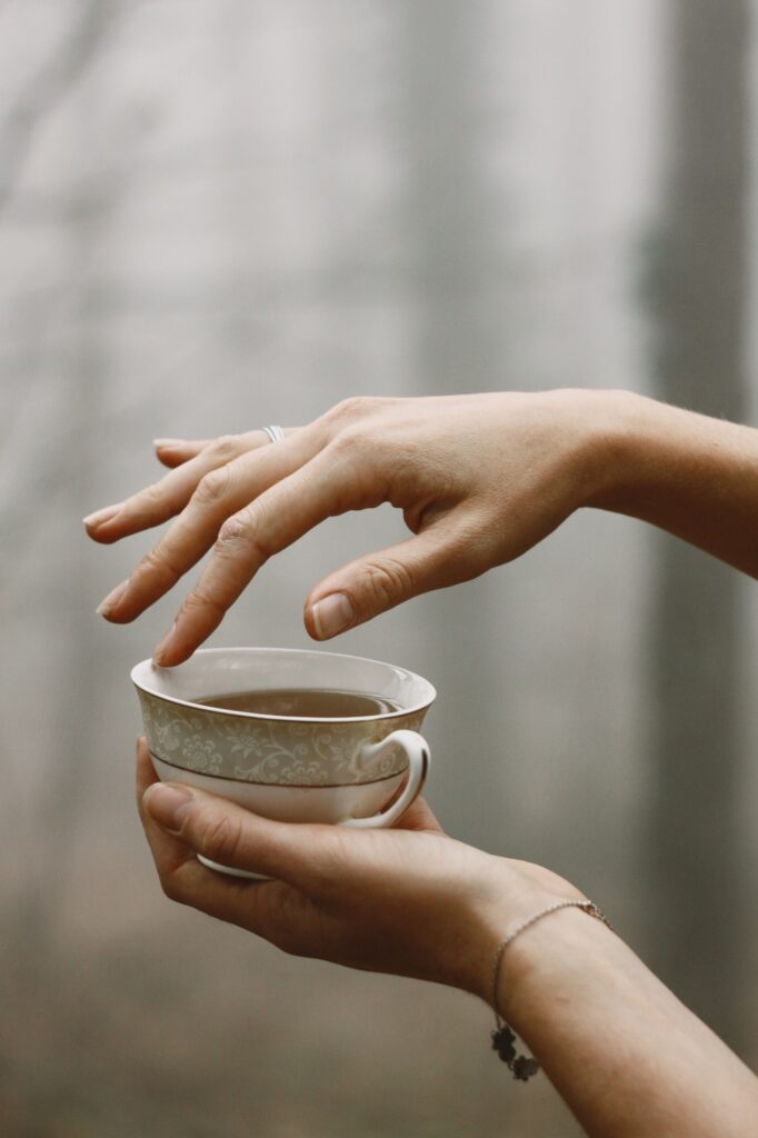 female hands holding a cup of tea